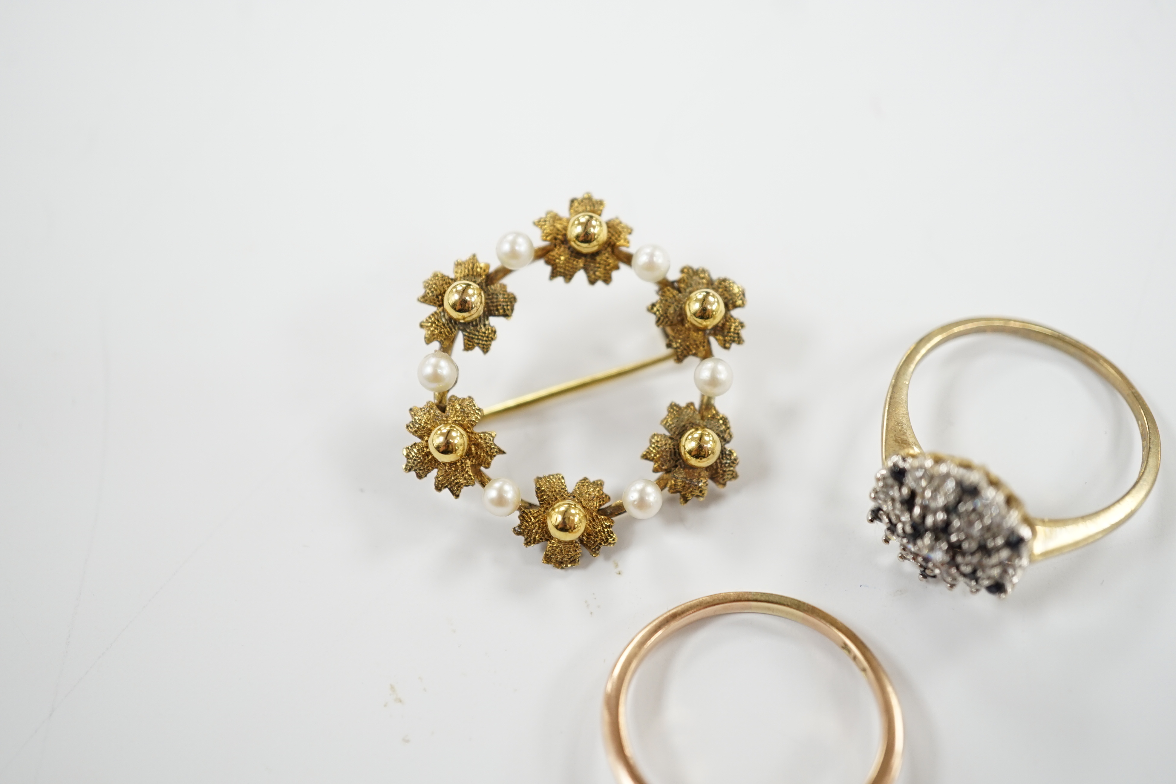 A 9ct gold and two colour sapphire cluster set dress ring, one other 9ct and opal ring and a 9ct gold and cultured pearl set open work circular brooch, gross weight 8.5 grams.